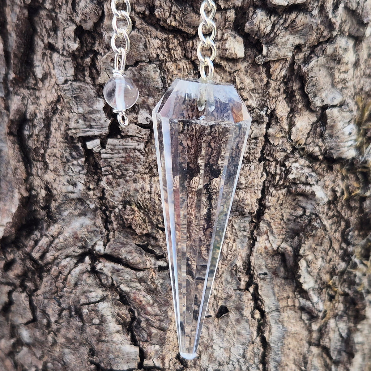 Facet cut shaped quartz crystal pendulum enhancing your dowsing experience, can be used for energy work, healing and during psychic readings.