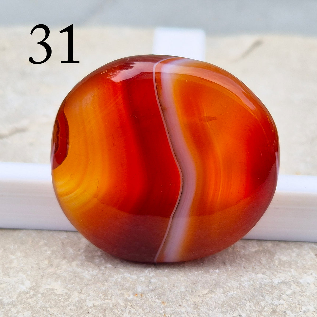 Banded Carnelian palm stone that is said to help Boost motivation, confidence and creativity. Grounding Root and Sacral crystal for energy and focus.