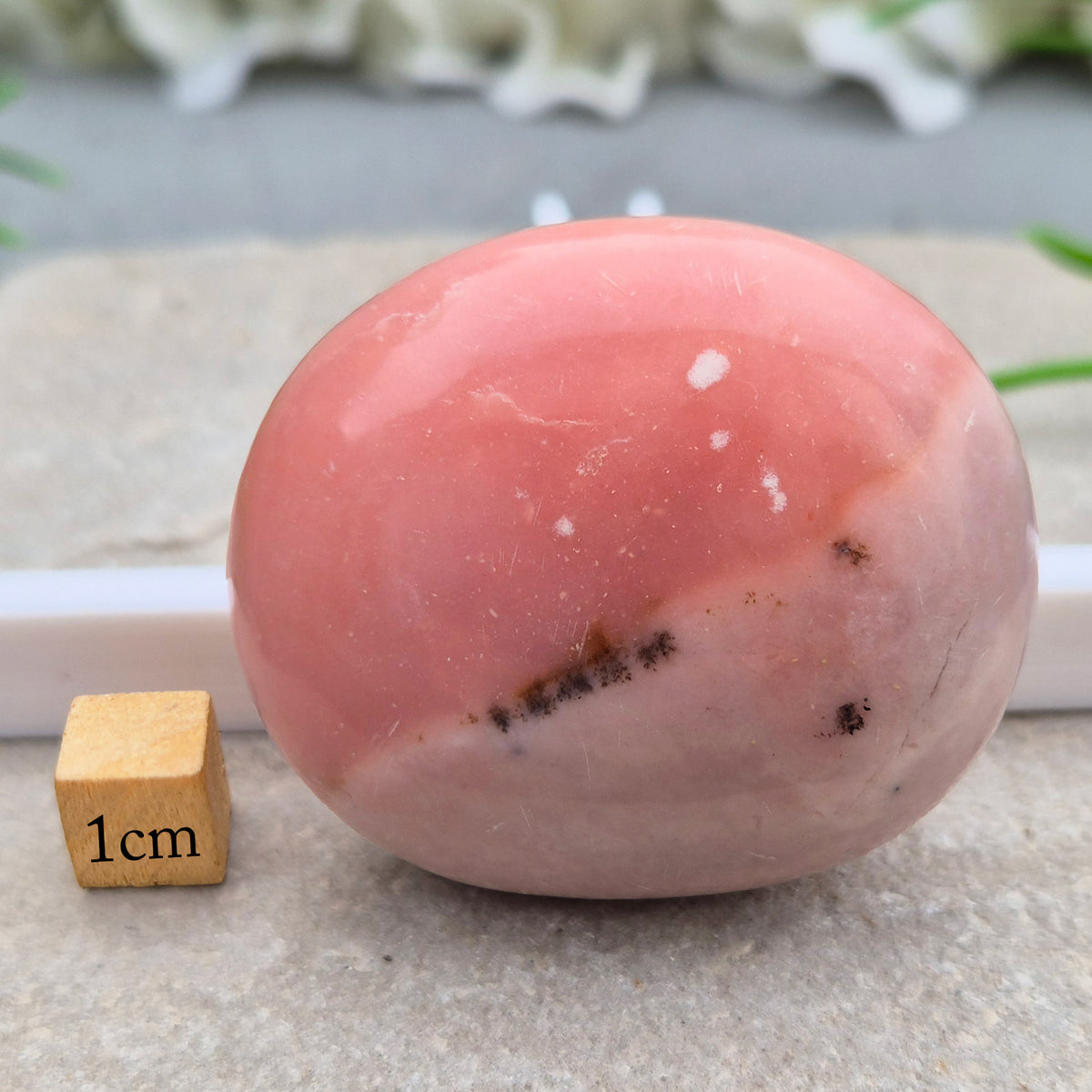 Pink Opal palm stone from Peru with soft pink to salmon tones and a glossy polish. A gentle heart chakra crystal for grief, heartbreak and emotional healing.