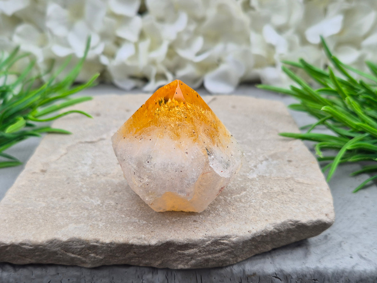 Citrine crystal standing point from Brazil with a polished tip and natural sides. Associated with confidence, motivation, positivity, and personal growth.