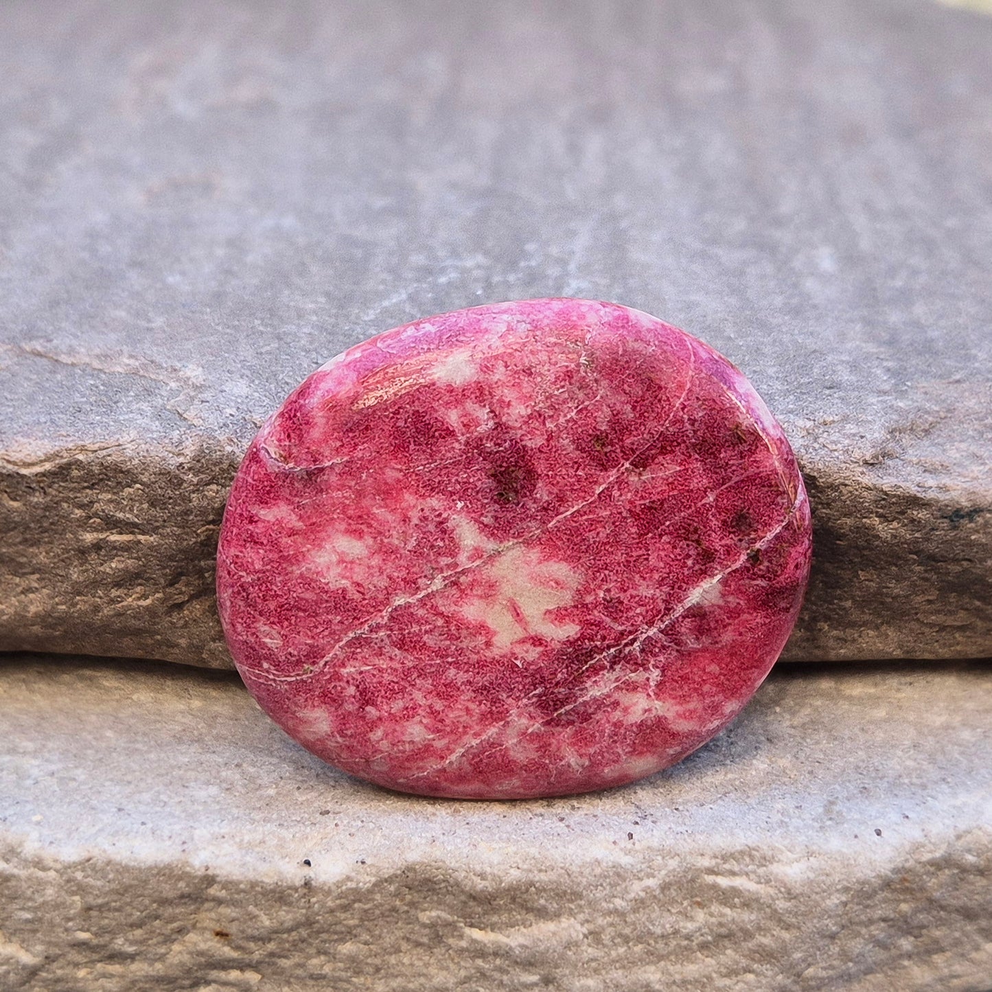 Pink Thulite palm stone – handpicked for heart and sacral chakra support. Encourages passion, creativity, and healthy emotional expression.