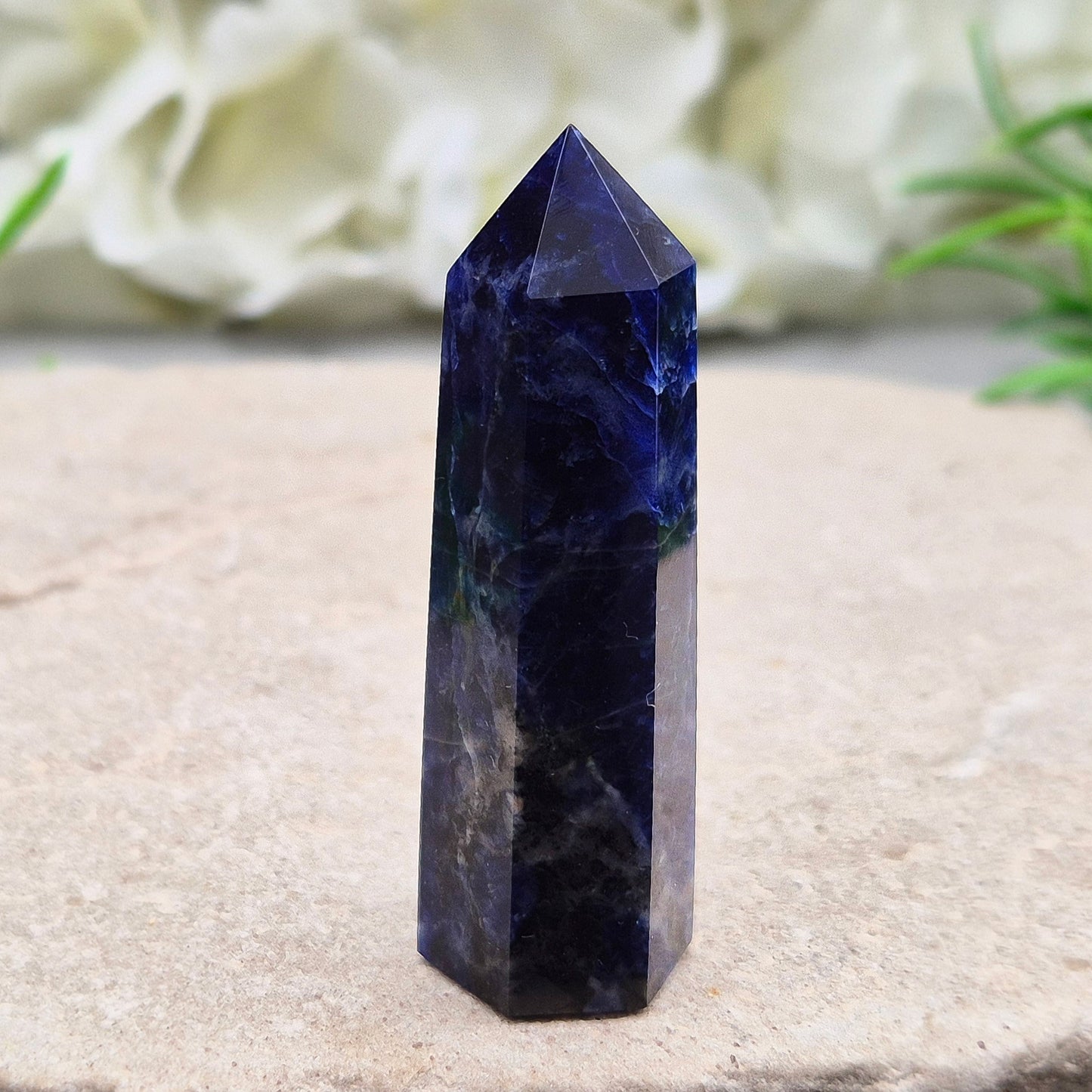Beautiful Sodalite point that promotes insight, confidence, and inner peace. A grounding crystal for clear communication and self-expression.
