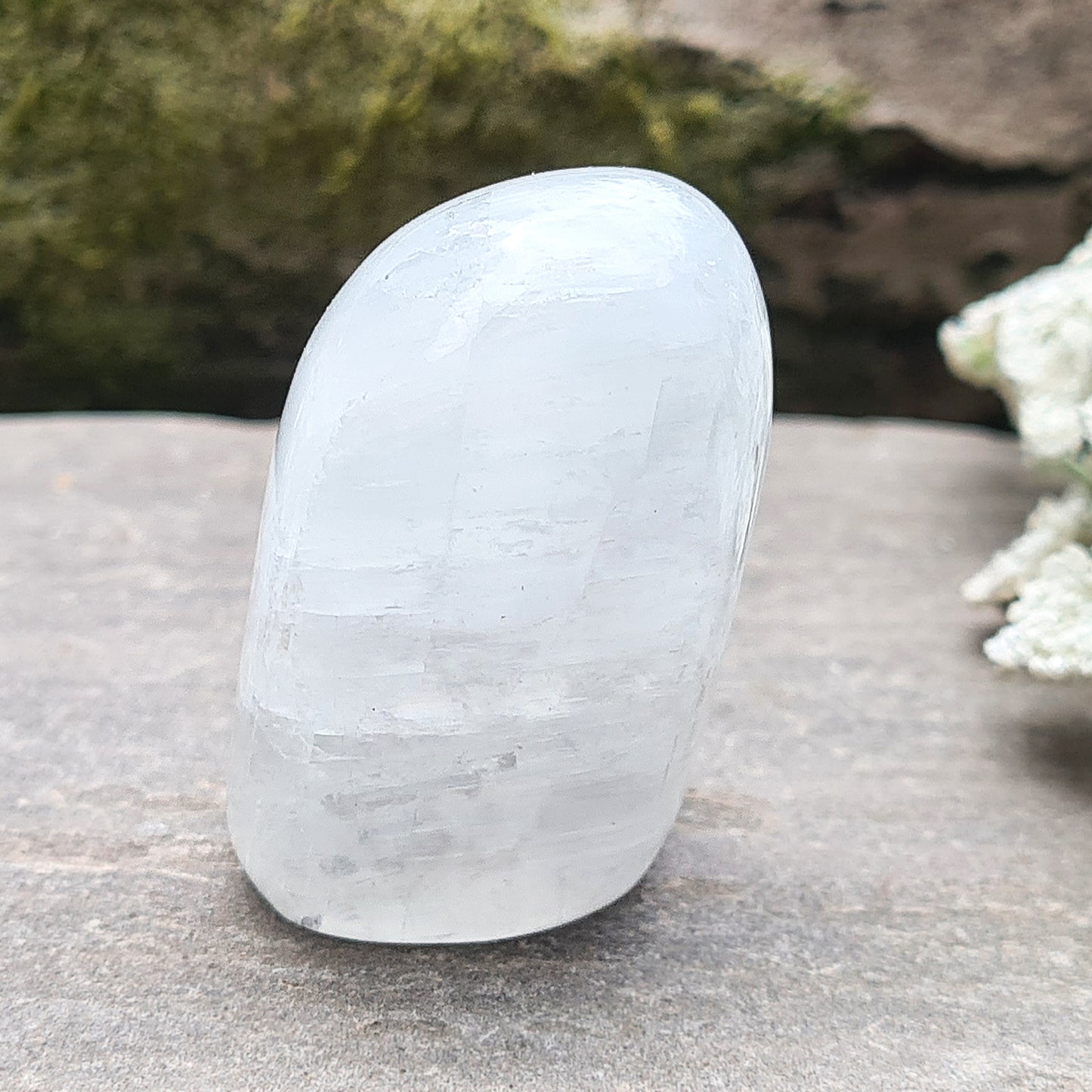 Calcite Freeform, White Calcite Freeform. In the light this crystal has a mother of pearl like lustre and a sparkle to it and it does display rainbows in some light conditions.