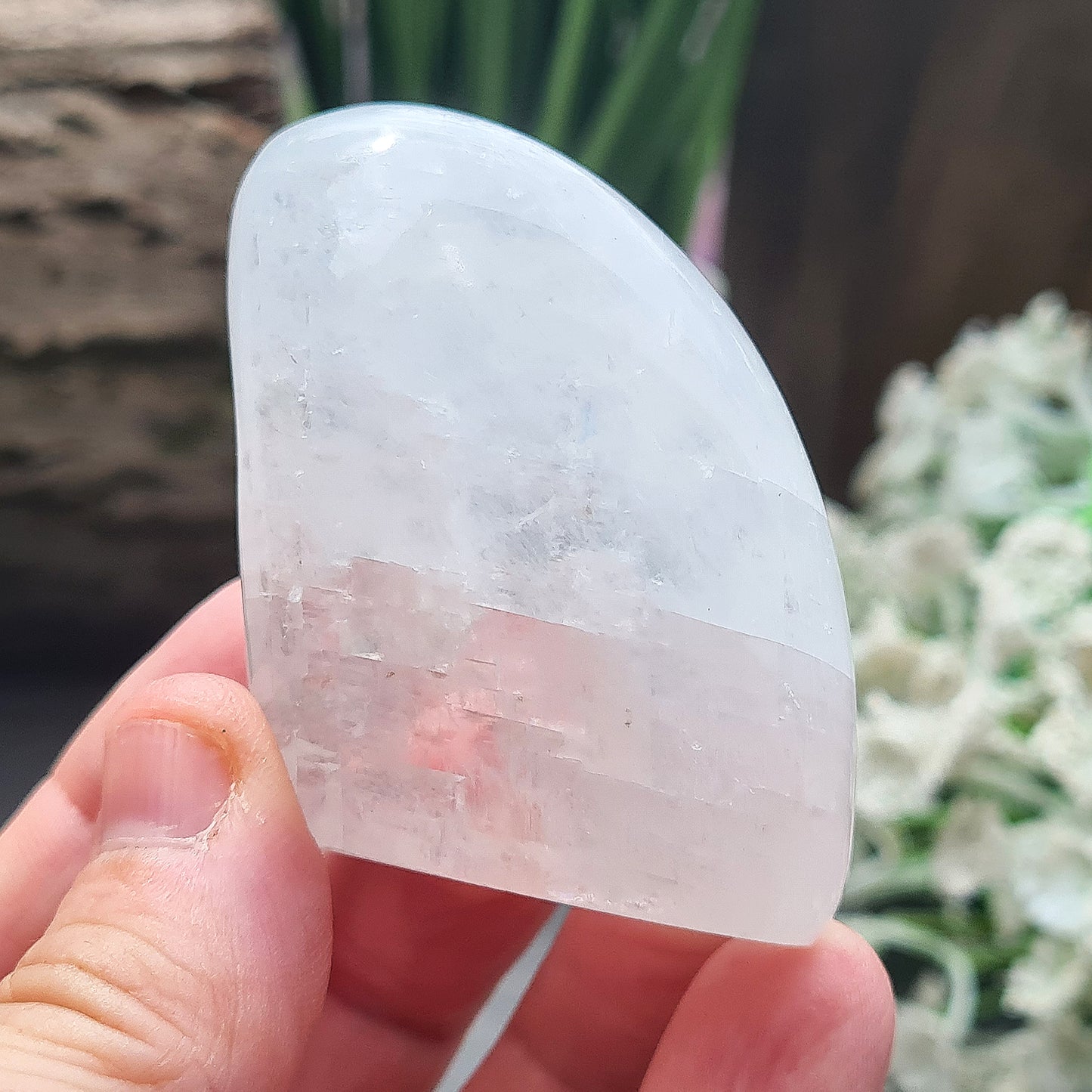 Calcite Freeform, White Calcite Freeform. In the light this crystal has a mother of pearl like lustre and a sparkle to it and it does display rainbows in some light conditions.