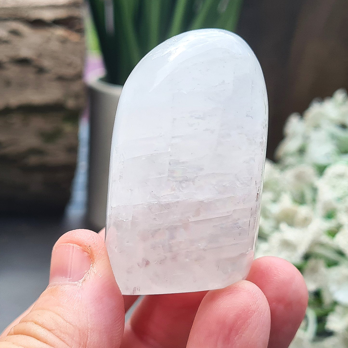 Calcite Freeform, White Calcite Freeform. In the light this crystal has a mother of pearl like lustre and a sparkle to it and it does display rainbows in some light conditions.
