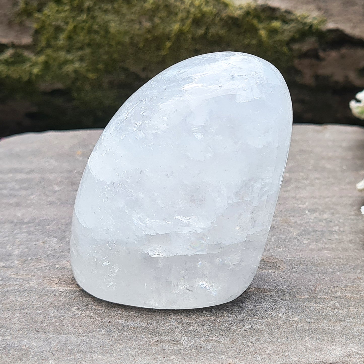Calcite Freeform, White Calcite Freeform. In the light this crystal has a mother of pearl like lustre and a sparkle to it and it does display rainbows in some light conditions.