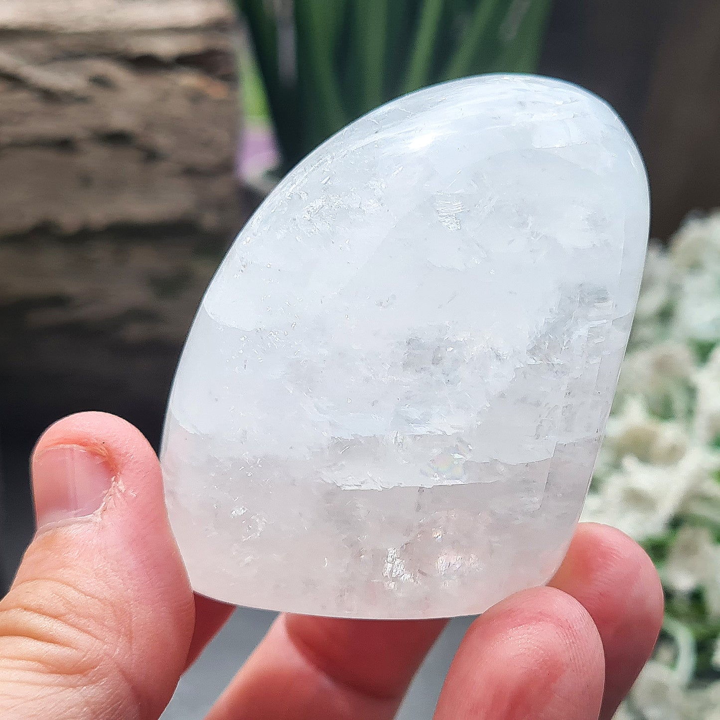 Calcite Freeform, White Calcite Freeform. In the light this crystal has a mother of pearl like lustre and a sparkle to it and it does display rainbows in some light conditions.