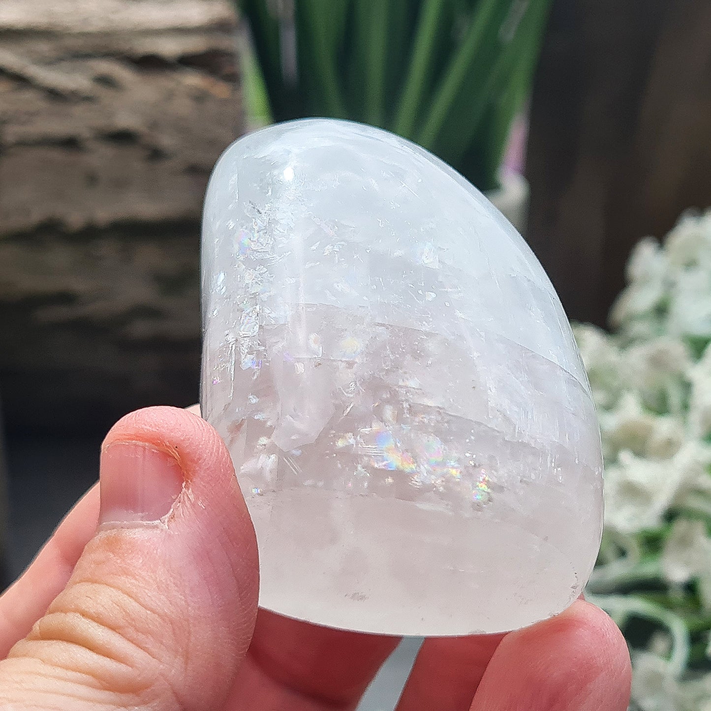 Calcite Freeform, White Calcite Freeform. In the light this crystal has a mother of pearl like lustre and a sparkle to it and it does display rainbows in some light conditions.