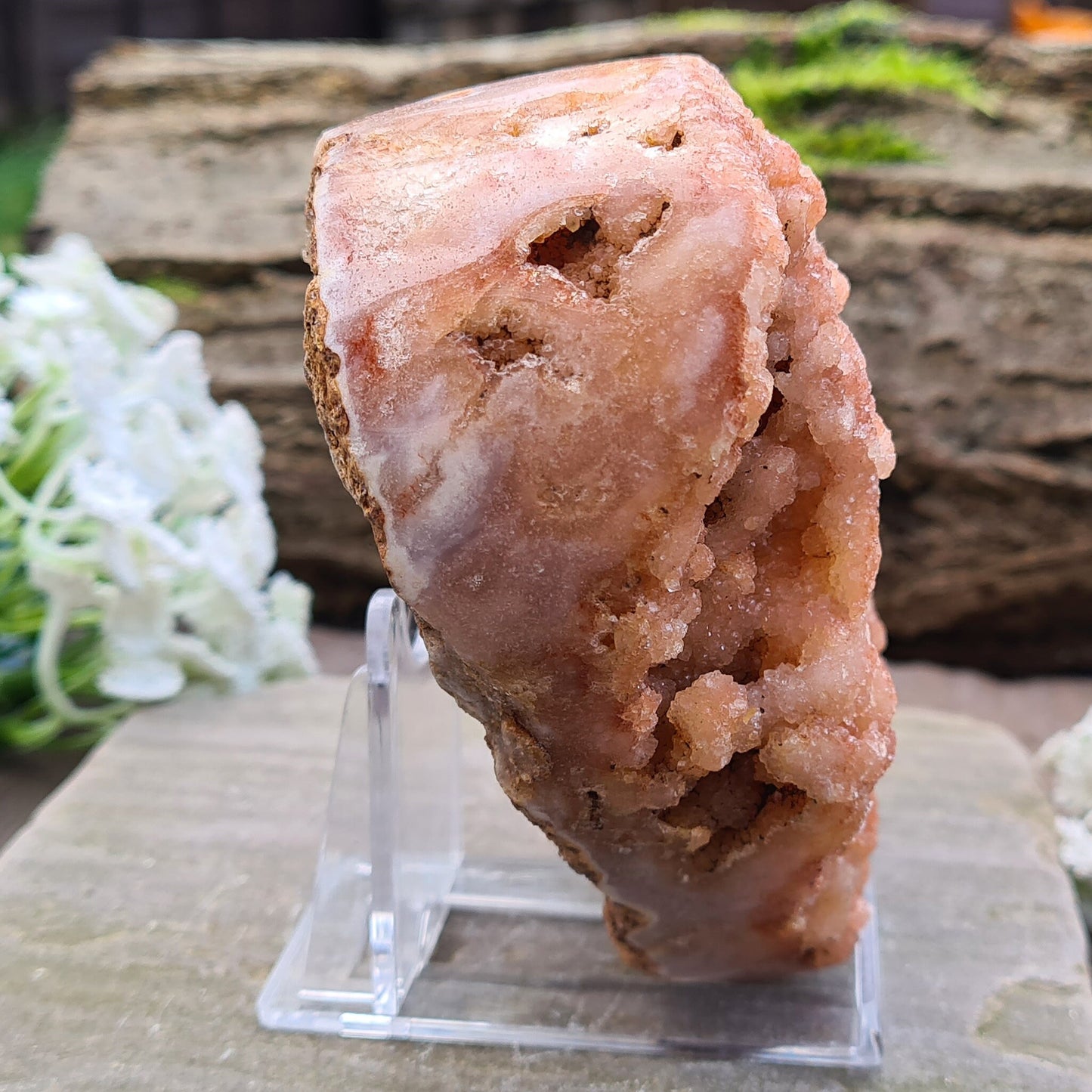 This striking Red Amethyst Heart showcases natural druzy crystal formations in shades of dusky pink/red. Its polished sides and natural base allow it to sit flat, while the included stand lets you display it upright as a beautiful statement piece.