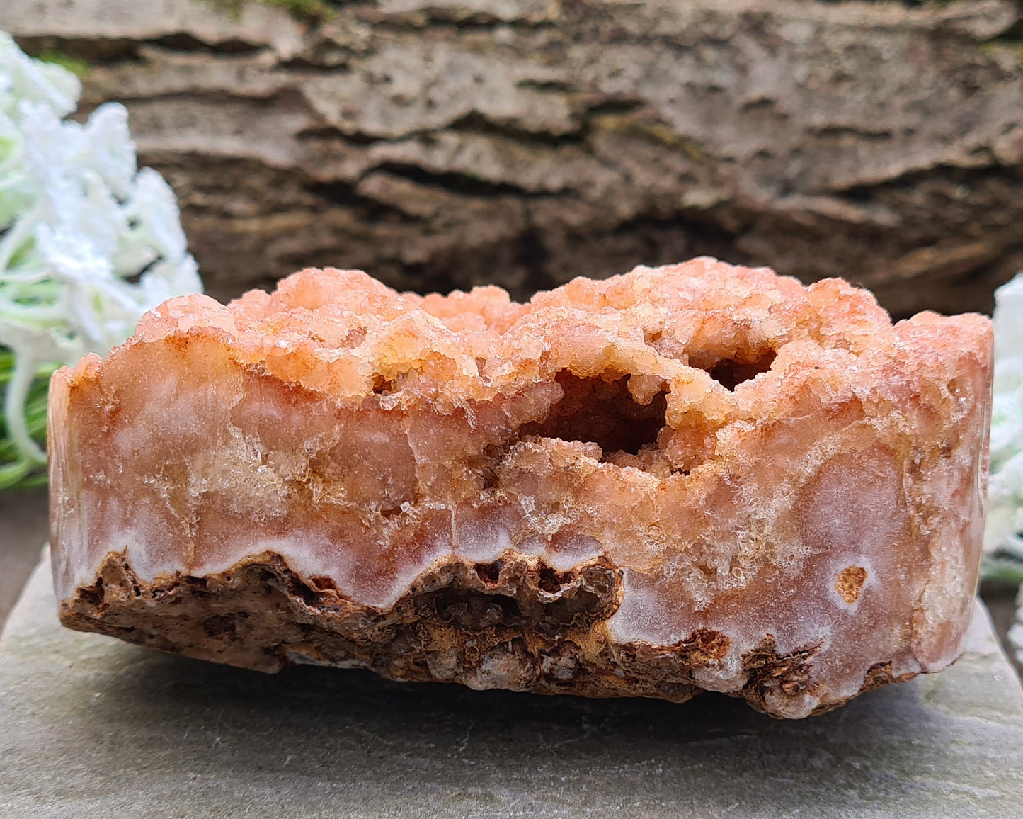 This striking Red Amethyst Heart showcases natural druzy crystal formations in shades of dusky pink/red. Its polished sides and natural base allow it to sit flat, while the included stand lets you display it upright as a beautiful statement piece.
