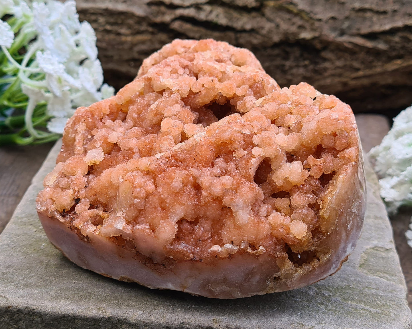 This striking Red Amethyst Heart showcases natural druzy crystal formations in shades of dusky pink/red. Its polished sides and natural base allow it to sit flat, while the included stand lets you display it upright as a beautiful statement piece.