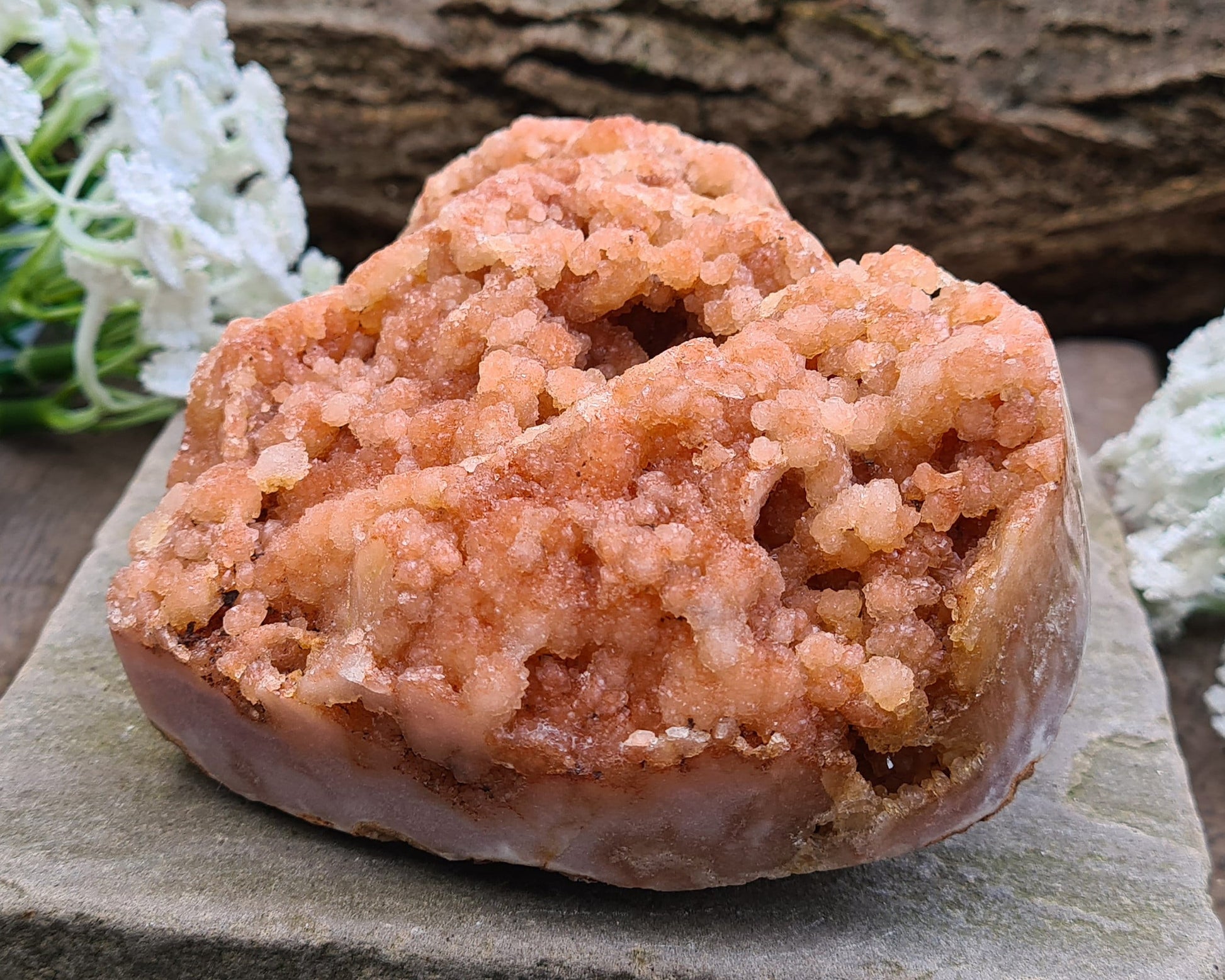 This striking Red Amethyst Heart showcases natural druzy crystal formations in shades of dusky pink/red. Its polished sides and natural base allow it to sit flat, while the included stand lets you display it upright as a beautiful statement piece.