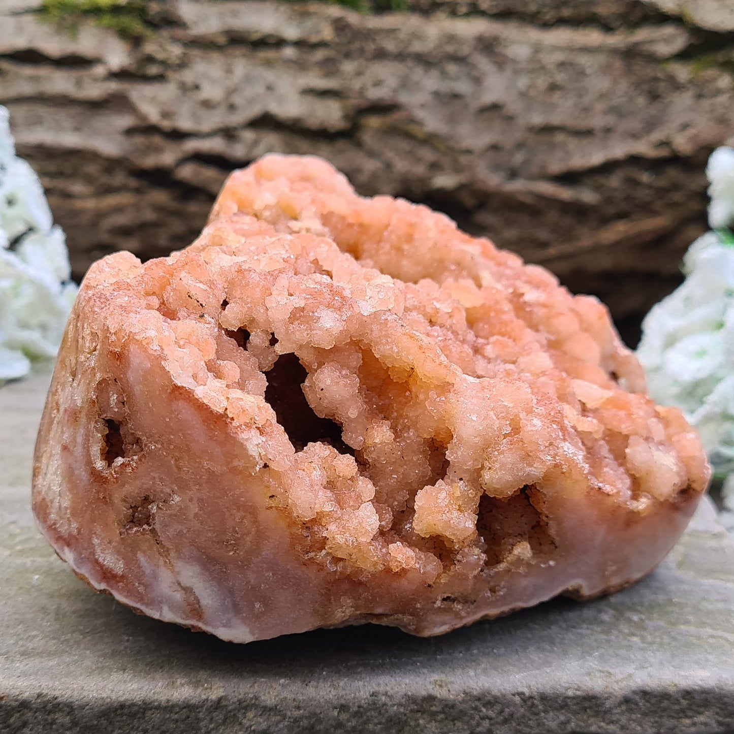 This striking Red Amethyst Heart showcases natural druzy crystal formations in shades of dusky pink/red. Its polished sides and natural base allow it to sit flat, while the included stand lets you display it upright as a beautiful statement piece.