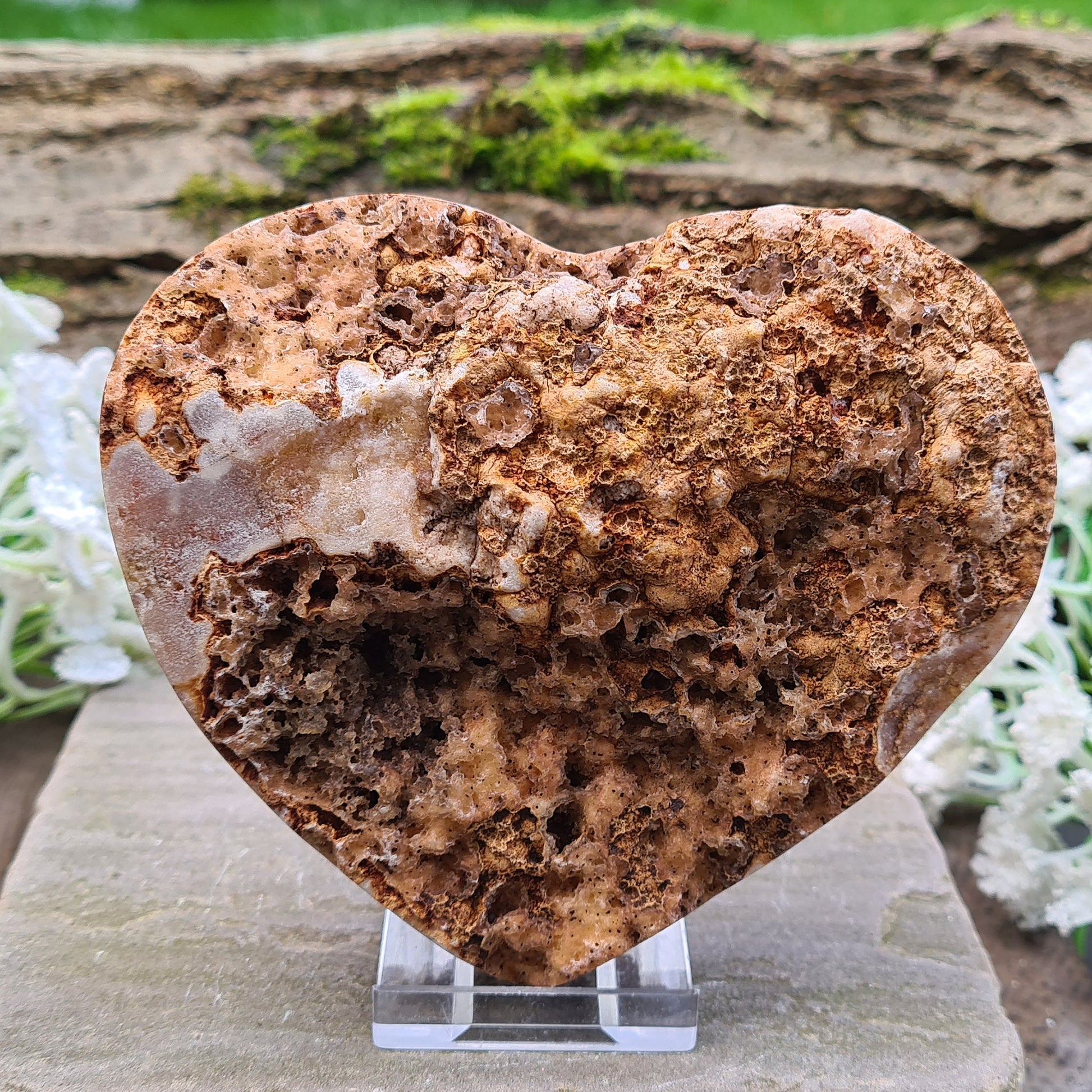 This striking Red Amethyst Heart showcases natural druzy crystal formations in shades of dusky pink/red. Its polished sides and natural base allow it to sit flat, while the included stand lets you display it upright as a beautiful statement piece.