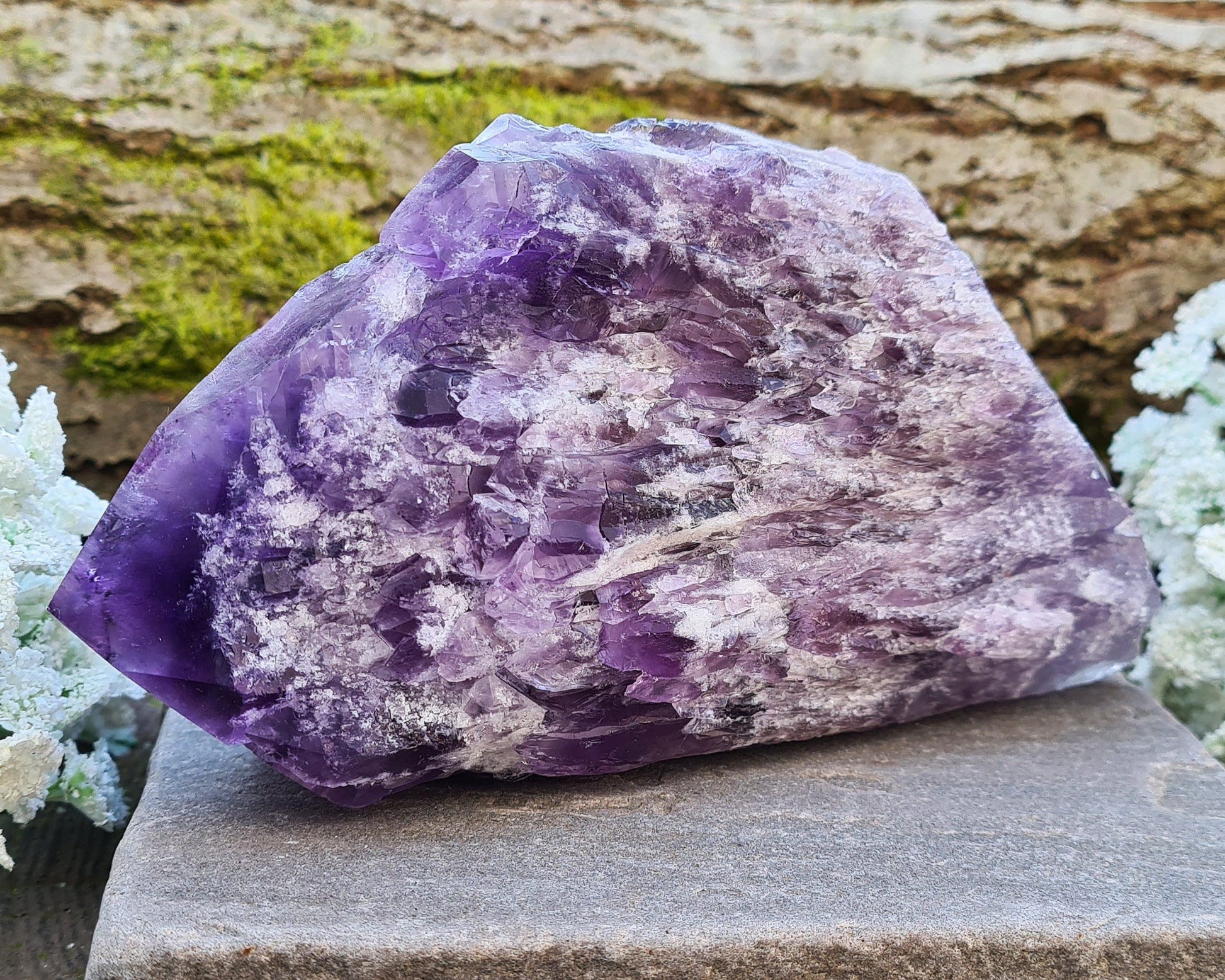 This striking Elestial Amethyst, also known as Bahia Amethyst or Amethyst Root features layered formations with multiple points and a large central termination. The shape is reminiscent of a fish — often associated with intuition and emotional depth. A beautiful rainbow in the “tail” adds a touch of light and joy to its already captivating presence.