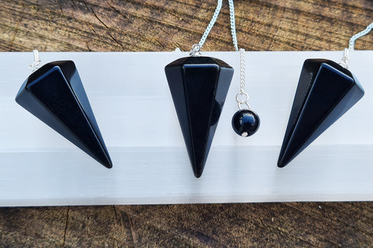 Black Obsidian Pendulum with chain and black bead at end of chain. Average Length of the obsidian pendulum - 3.5 cm. 