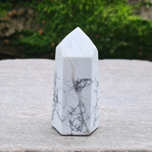 Howlite Point. Off White with grey marble like patterning, nicely polished. High grade.