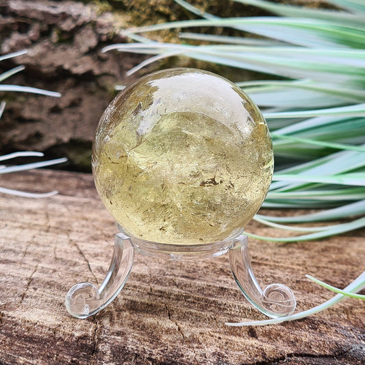 Smoky Quartz Sphere or Crystal Ball, from Brazil. This is a light yellowish brown with light reflecting inclusions. It has been known that some people will sell the Yellowish Brown Smoky Quartz as Smoky Citrine, but it is not Citrine. This ball has a small area of iron inclusion. 