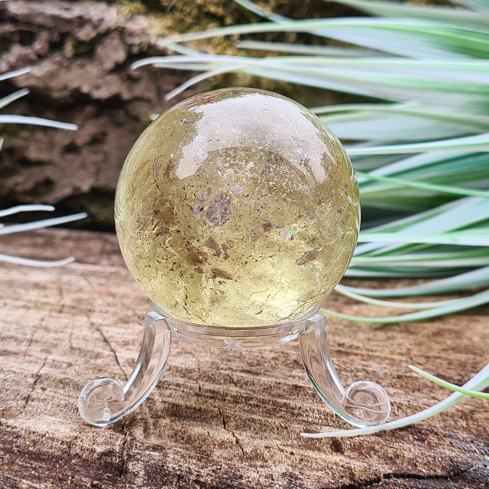 Smoky Quartz Sphere or Crystal Ball. This sphere has light reflecting inclusions and a small area of what I believe to be iron inclusion.
