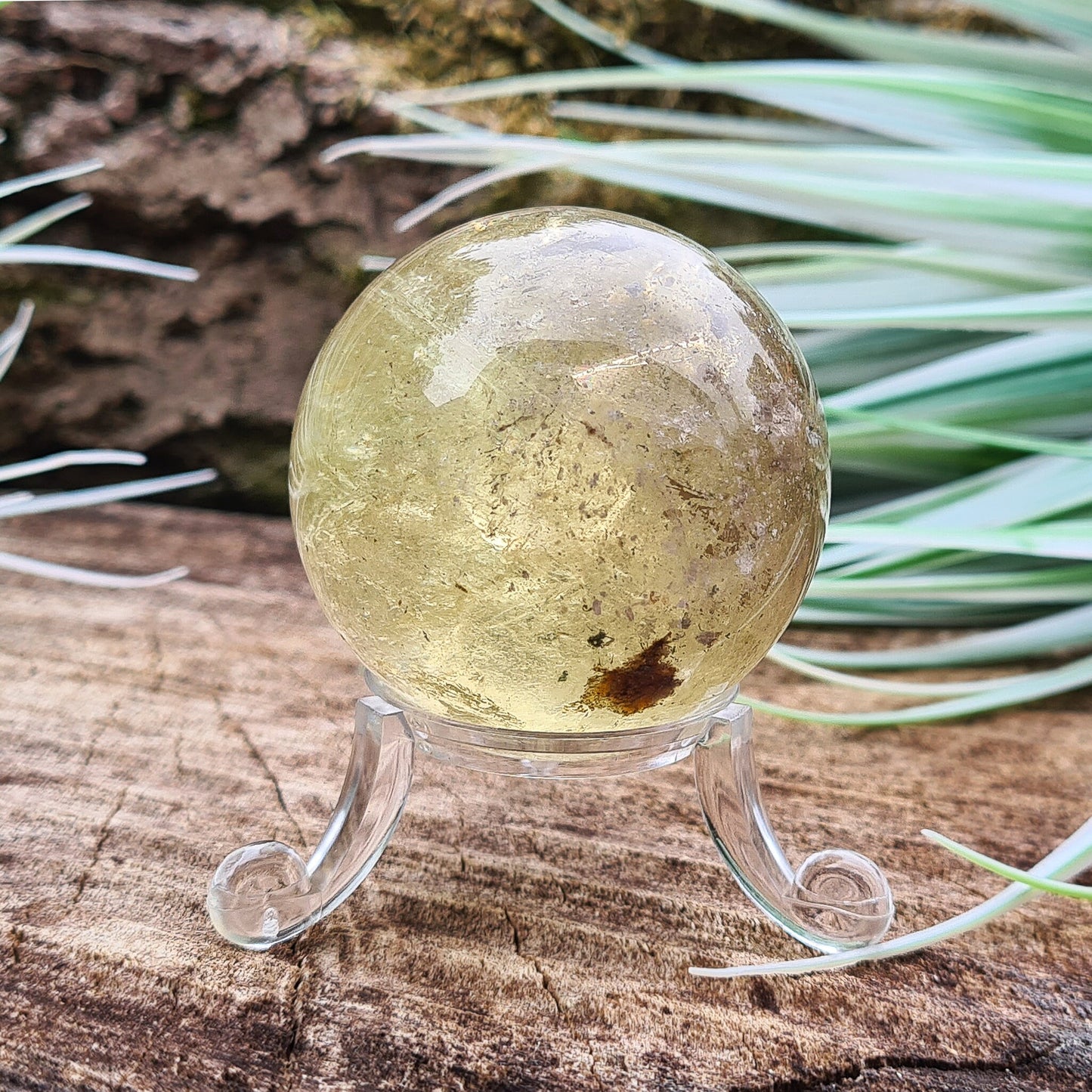 Smoky Quartz Sphere or Crystal Ball. This sphere has light reflecting inclusions and a small area of what I believe to be iron inclusion.