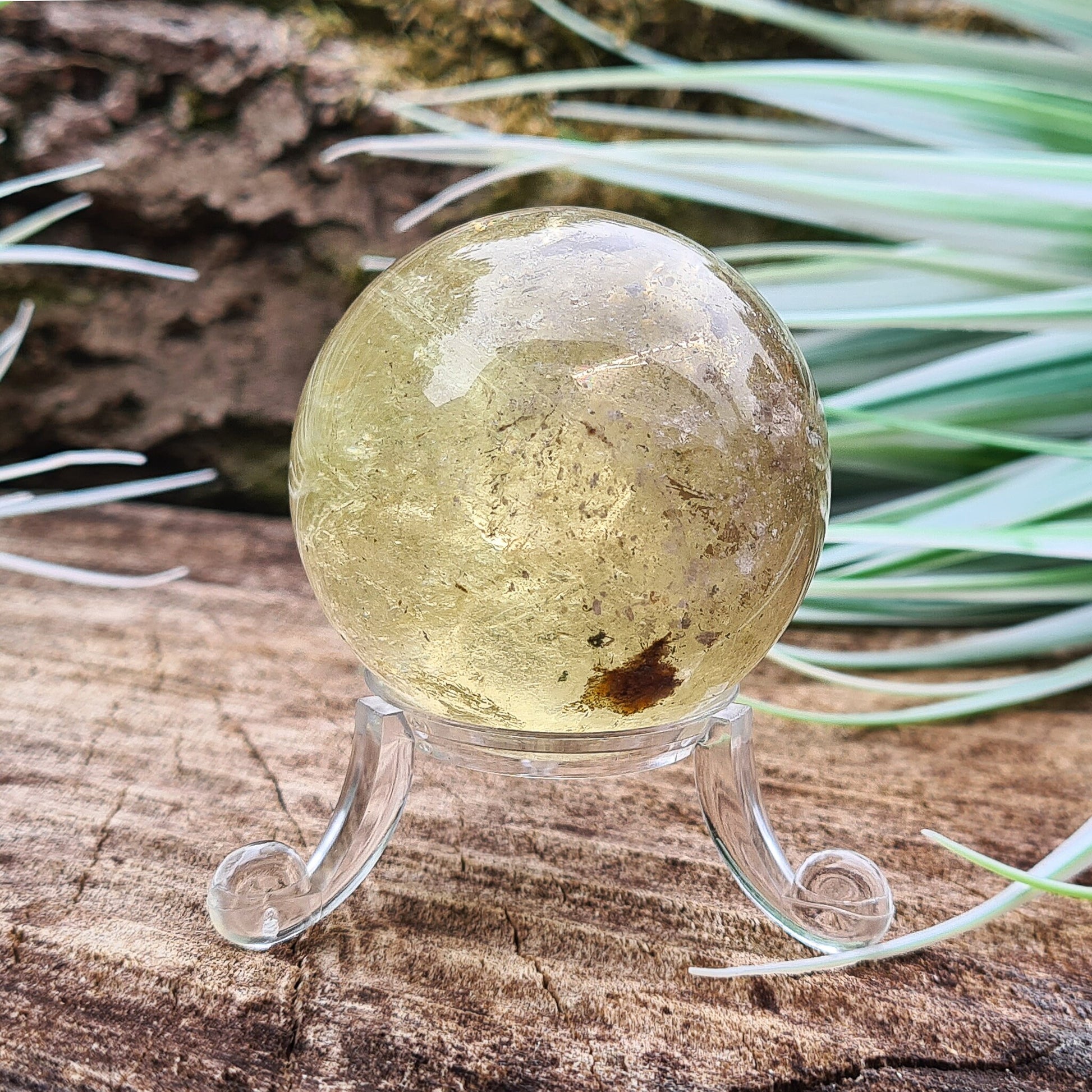 Smoky Quartz Sphere or Crystal Ball. This sphere has light reflecting inclusions and a small area of what I believe to be iron inclusion.