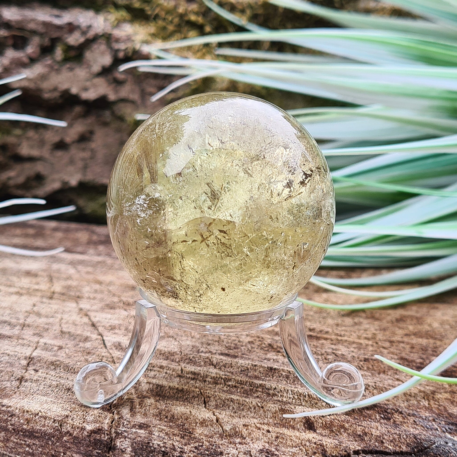 Smoky Quartz Sphere or Crystal Ball. This sphere has light reflecting inclusions and a small area of what I believe to be iron inclusion.