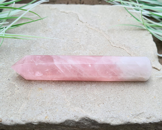 Rose Quartz Crystal Polished wand from Brazil. One end is a 6 sided point and the other end is rounded.