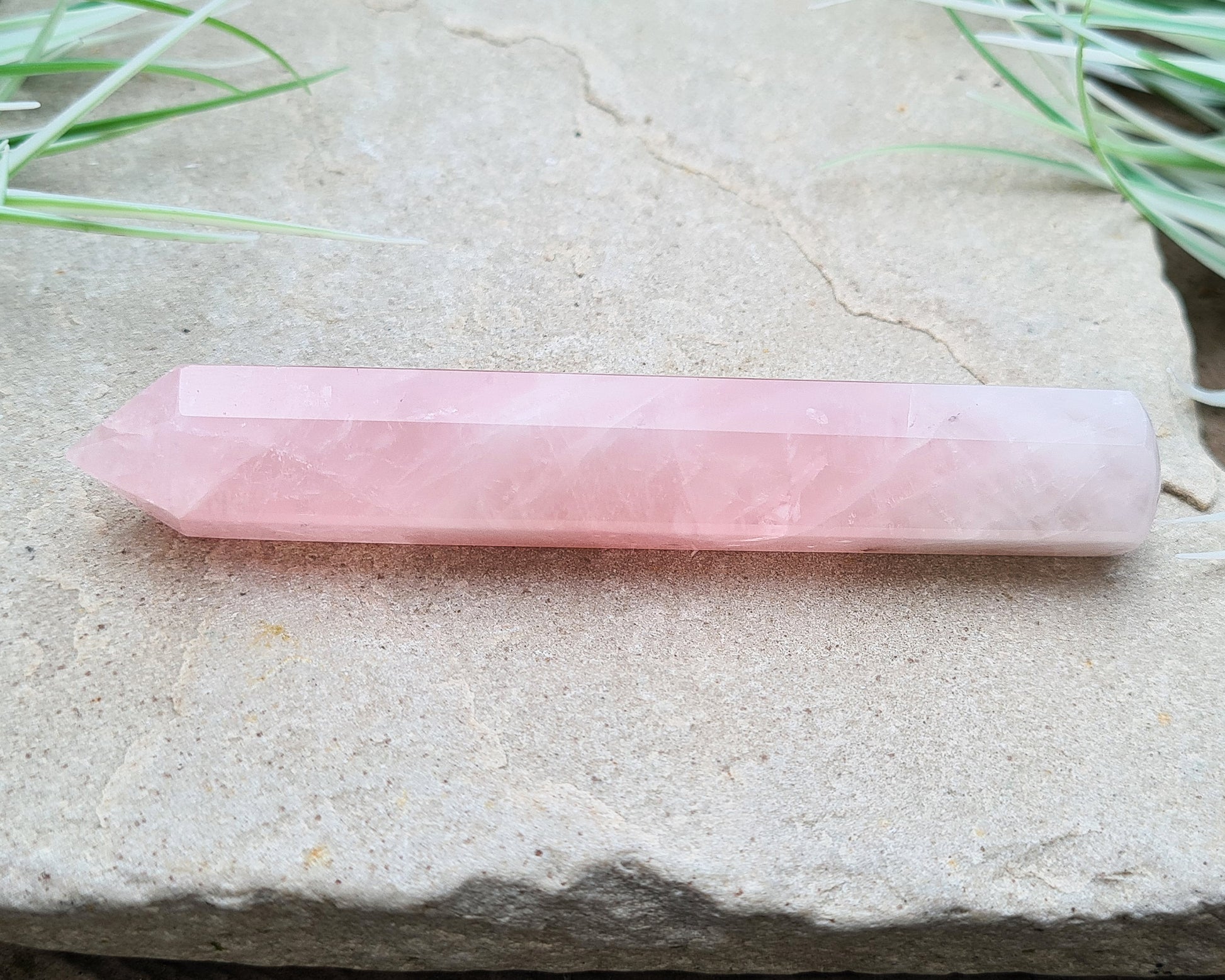 Rose Quartz Crystal Polished wand from Brazil. One end is a 6 sided point and the other end is rounded.