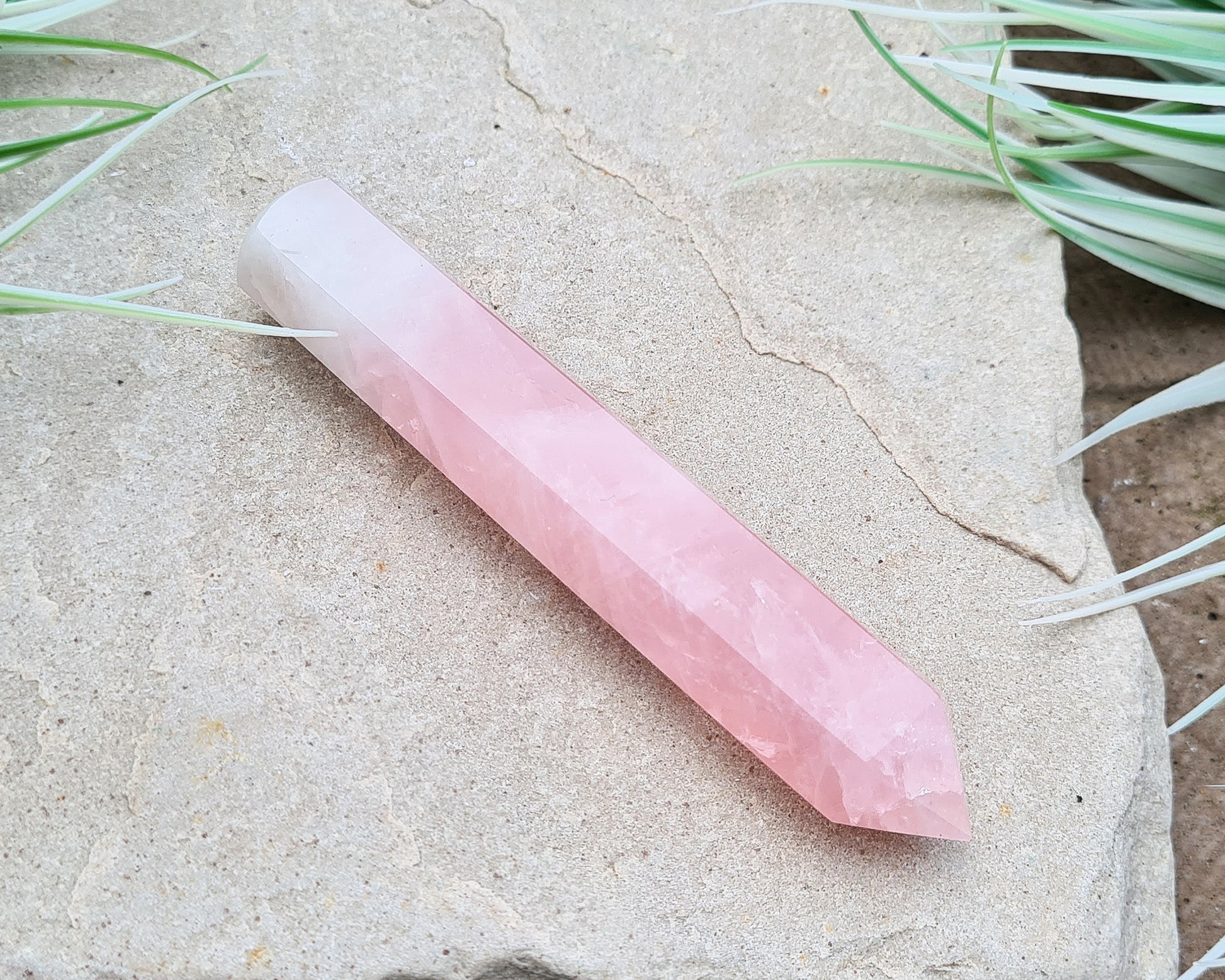 Rose Quartz Crystal Polished wand from Brazil. One end is a 6 sided point and the other end is rounded.