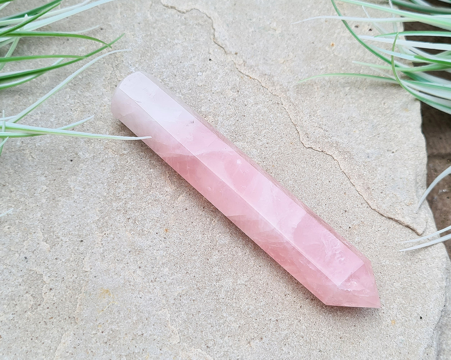 Rose Quartz Crystal Polished wand from Brazil. One end is a 6 sided point and the other end is rounded.