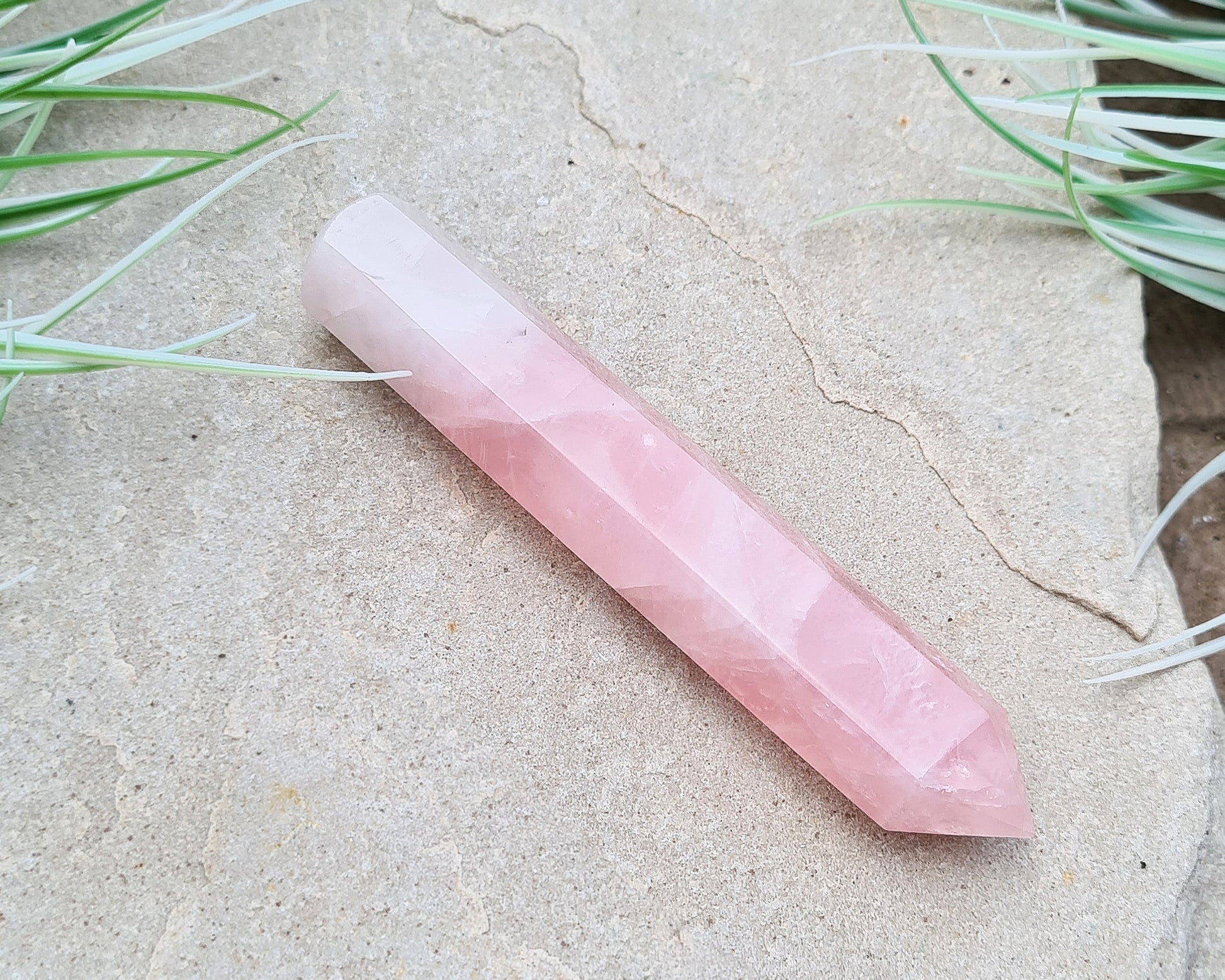 Rose Quartz Crystal Polished wand from Brazil. One end is a 6 sided point and the other end is rounded.
