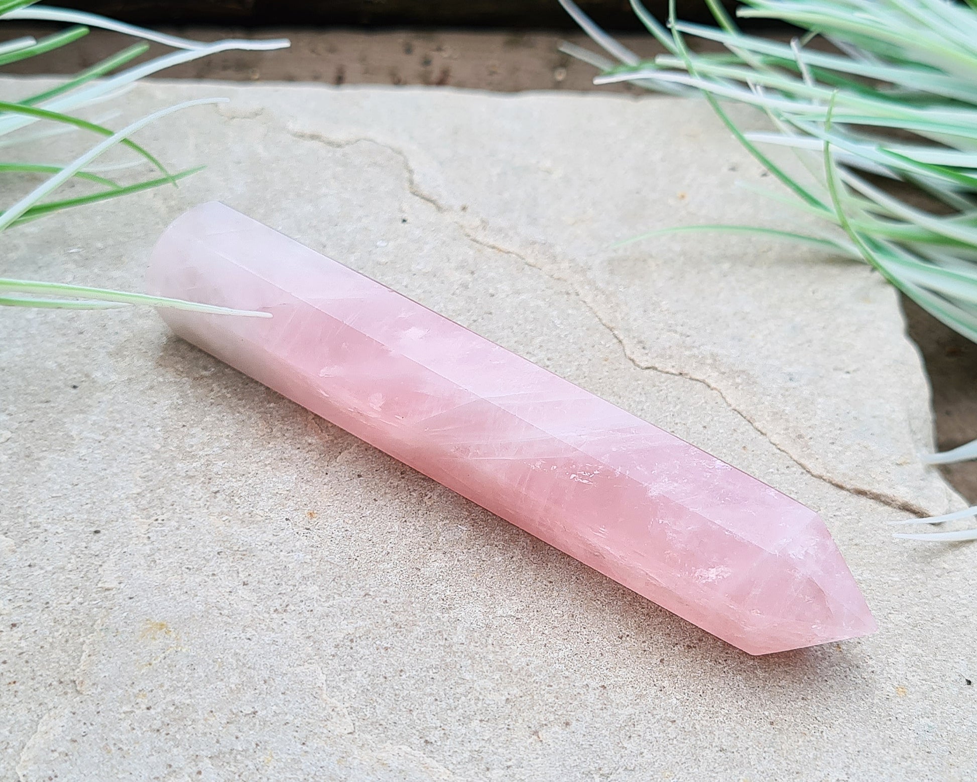 Rose Quartz Crystal Polished wand from Brazil. One end is a 6 sided point and the other end is rounded.