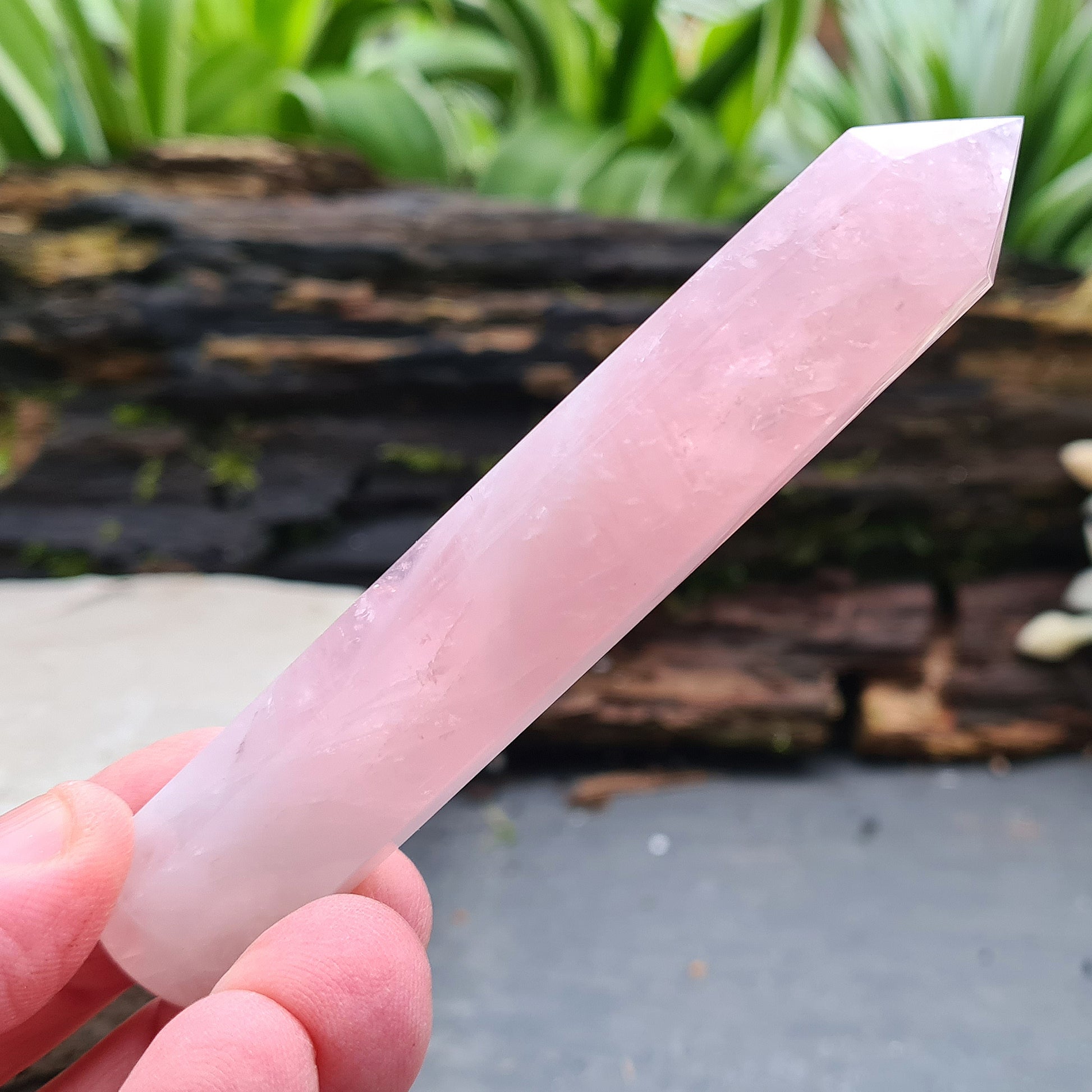 Rose Quartz Crystal Polished wand from Brazil. One end is a 6 sided point and the other end is rounded.