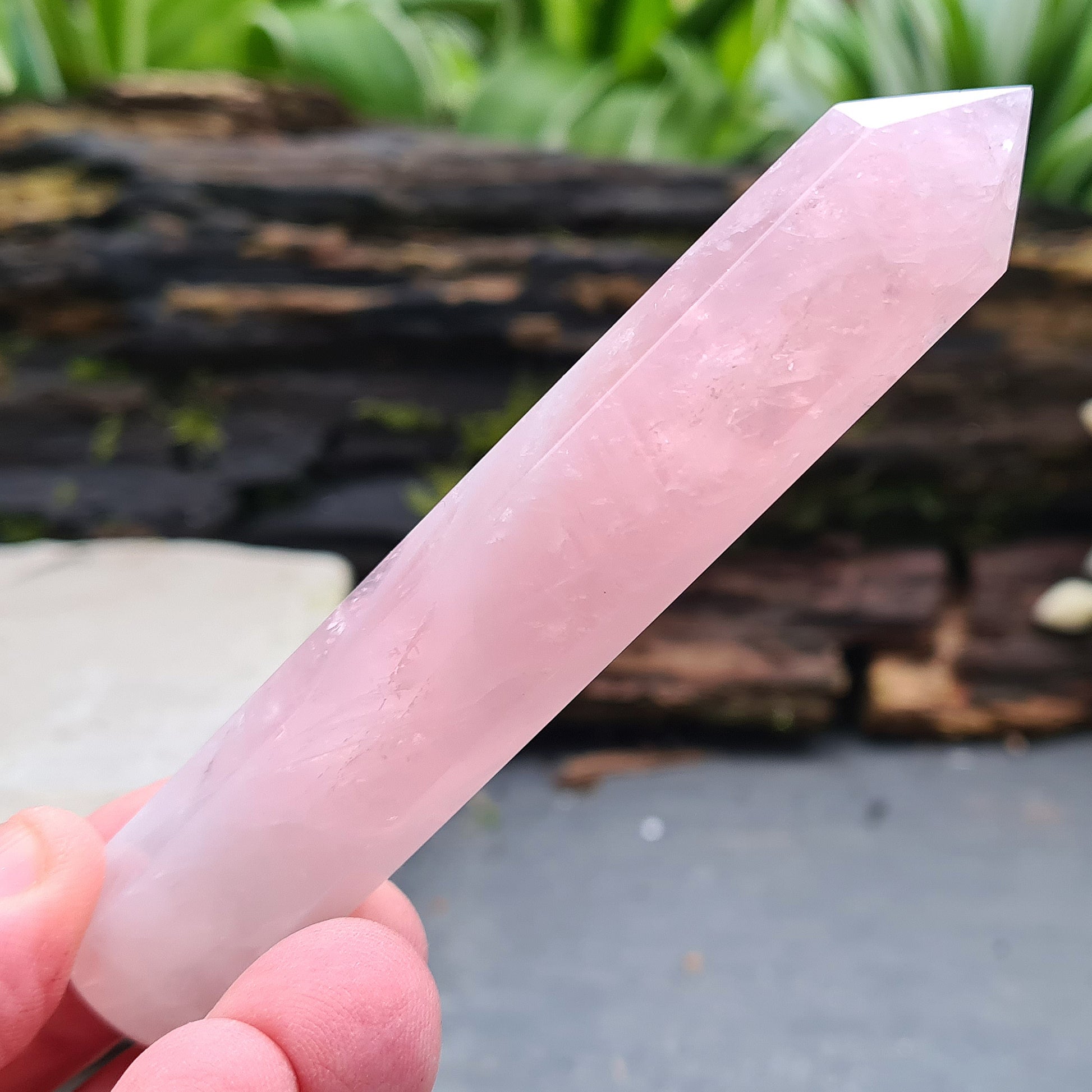Rose Quartz Crystal Polished wand from Brazil. One end is a 6 sided point and the other end is rounded.