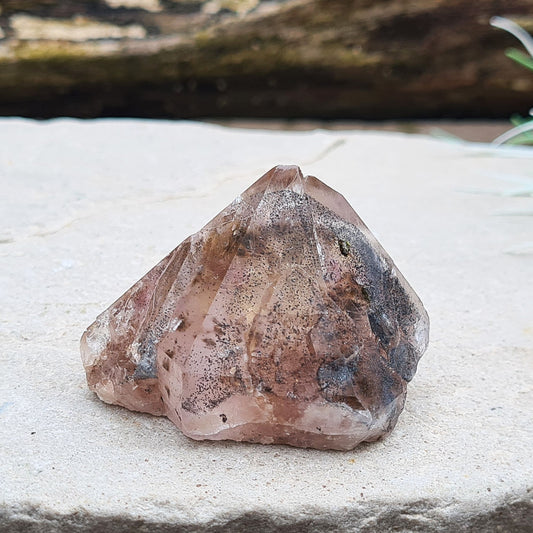 Amethyst and Citrine with Hematite inclusions, natural point, from the Sichuan Province, China. Base is even enough that it can sit on an even surface.