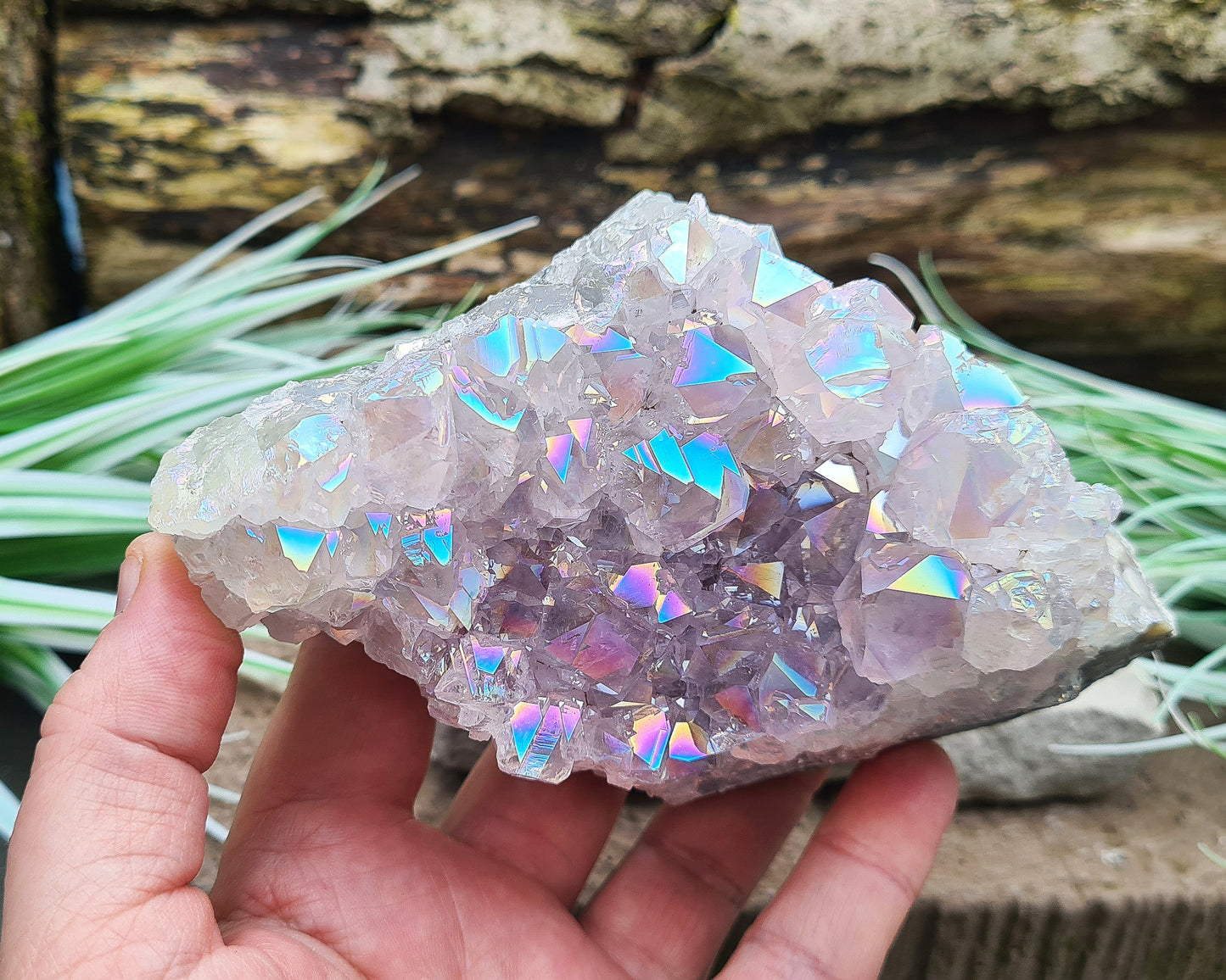 Aura Amethyst Crystal Cluster from Brazil, featuring a vibrant 'rainbow' effect created by bonding amethyst with gold and iridium. The crystals display fabulous bright colors that shift and shine when moved in the light.