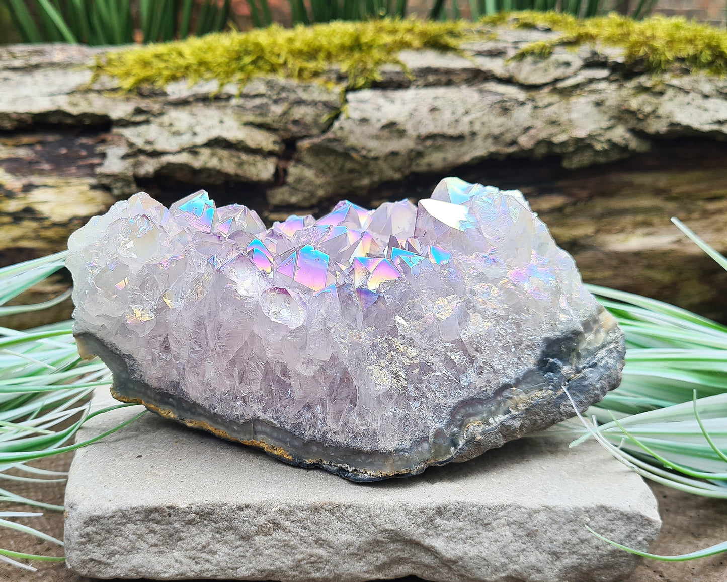 Aura Amethyst Crystal Cluster from Brazil, featuring a vibrant 'rainbow' effect created by bonding amethyst with gold and iridium. The crystals display fabulous bright colors that shift and shine when moved in the light.