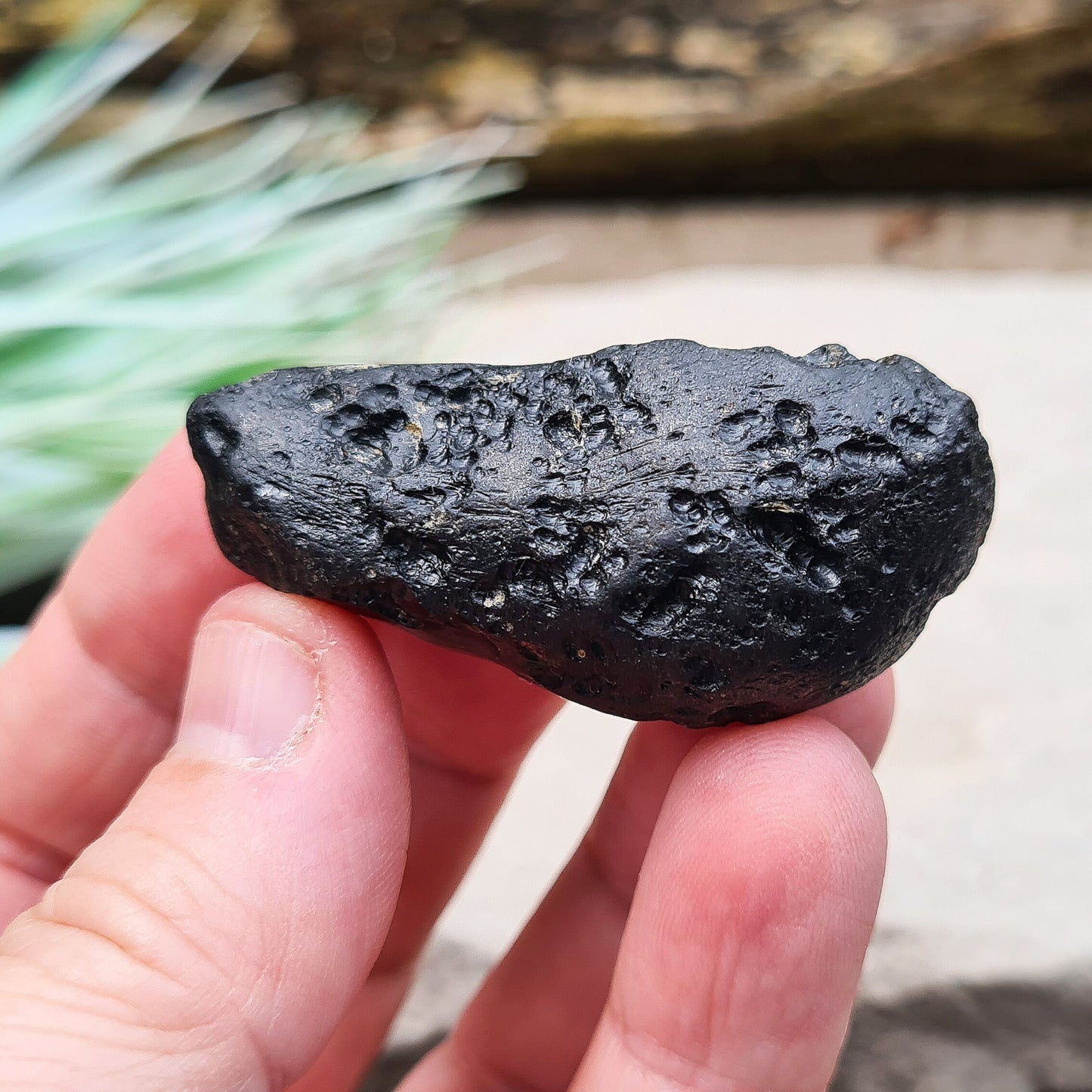 Black Indochinite Tektite, A Grade. A dark black tektite formed from meteorite impact, with a glass-like structure. Estimated to be 700,000 years old, these tektites are found in the Indochinese peninsula, stretching from Australia to China and Indonesia.