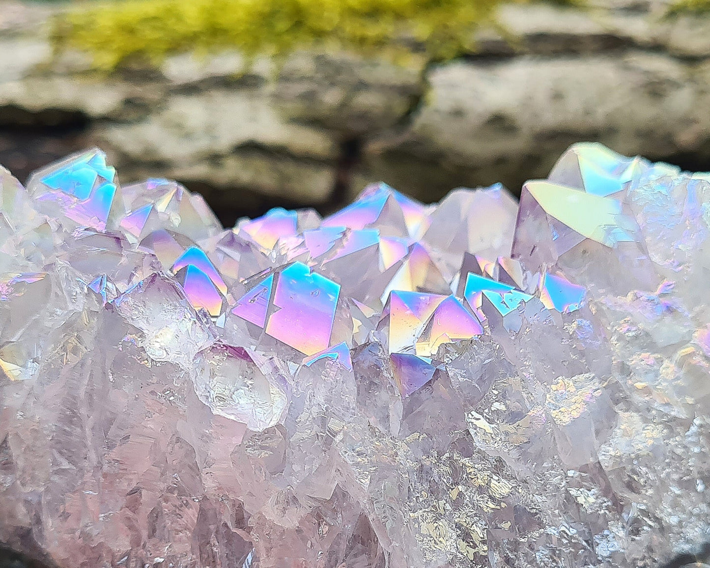 Aura Amethyst Crystal Cluster from Brazil, featuring a vibrant 'rainbow' effect created by bonding amethyst with gold and iridium. The crystals display fabulous bright colors that shift and shine when moved in the light.