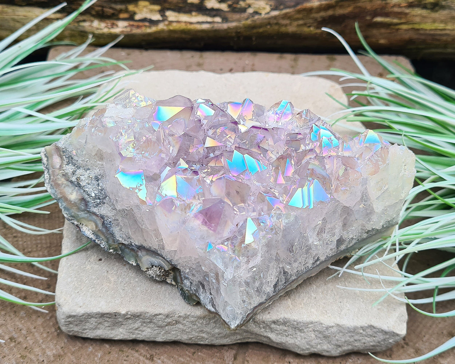 Aura Amethyst Crystal Cluster from Brazil, featuring a vibrant 'rainbow' effect created by bonding amethyst with gold and iridium. The crystals display fabulous bright colors that shift and shine when moved in the light.