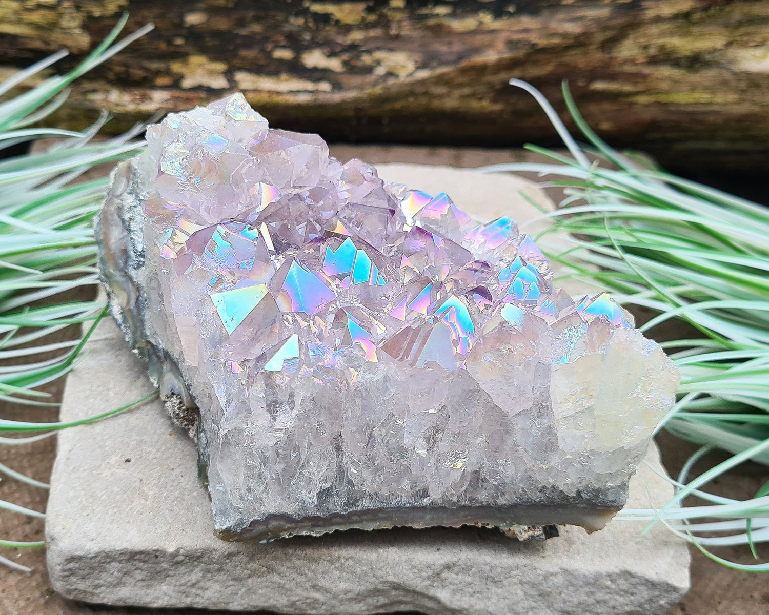 Aura Amethyst Crystal Cluster from Brazil, featuring a vibrant 'rainbow' effect created by bonding amethyst with gold and iridium. The crystals display fabulous bright colors that shift and shine when moved in the light.