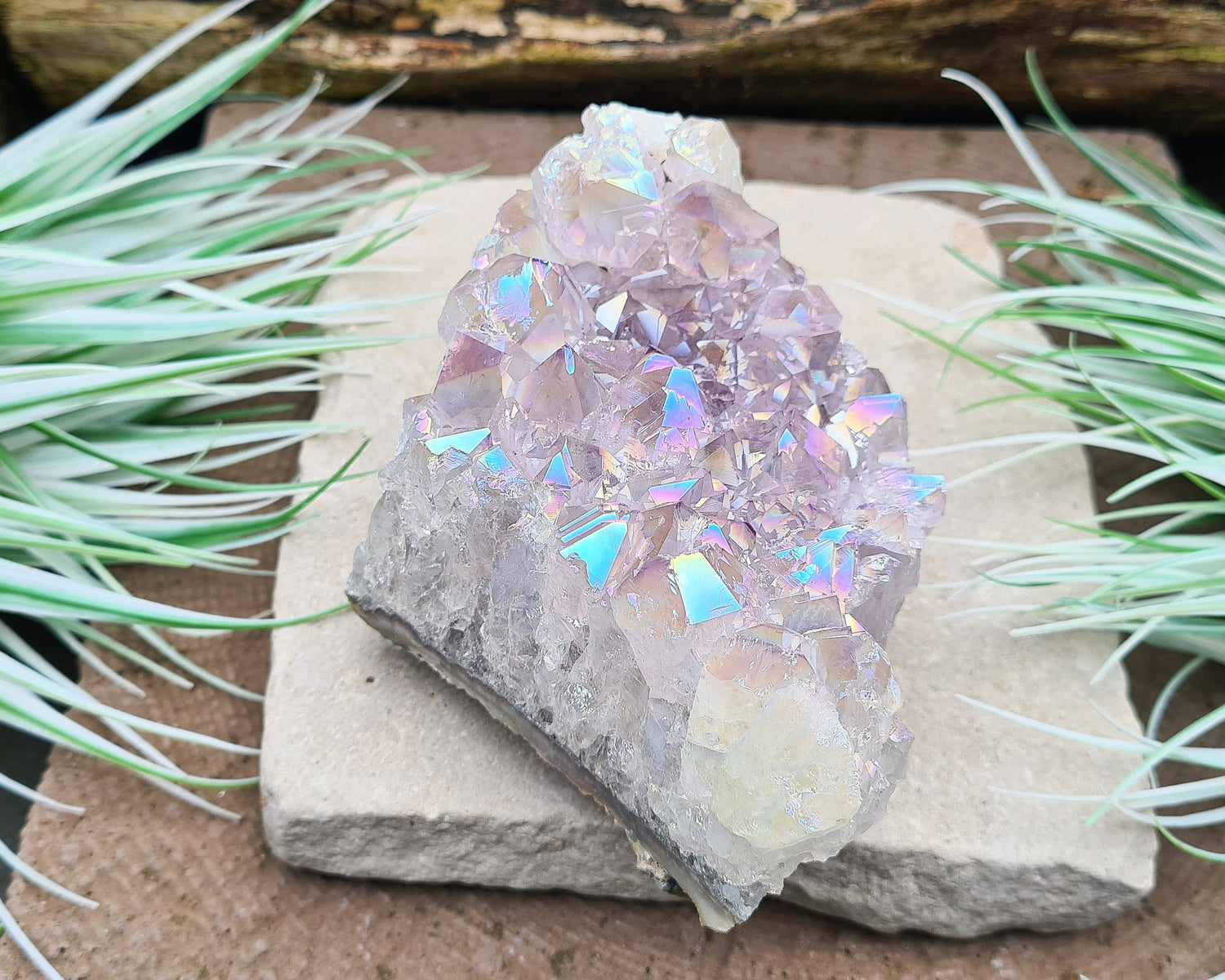 Aura Amethyst Crystal Cluster from Brazil, featuring a vibrant 'rainbow' effect created by bonding amethyst with gold and iridium. The crystals display fabulous bright colors that shift and shine when moved in the light.