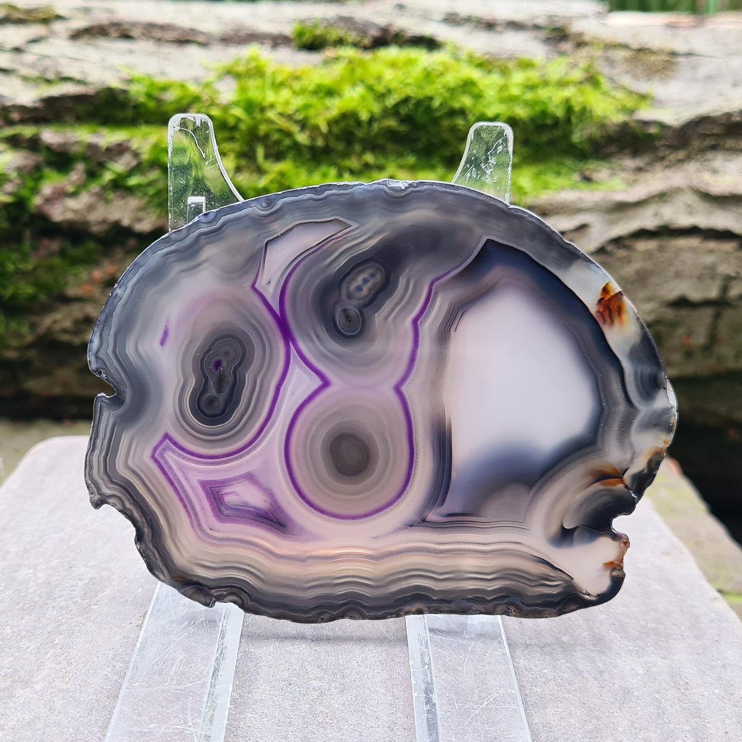 Agate Crystal Slice from Brazil, with stunning patterning and colouring. The edges have been left natural, the rest of the slice is polished. Stand not included.