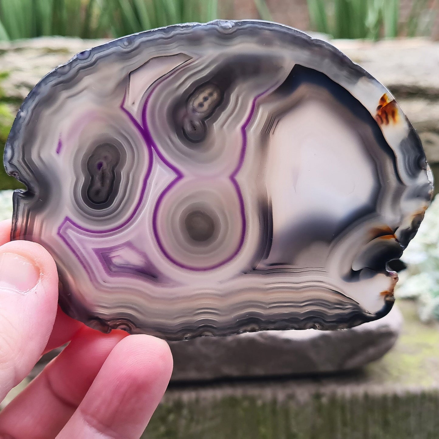 Agate Crystal Slice from Brazil, with stunning patterning and colouring. The edges have been left natural, the rest of the slice is polished. Stand not included.