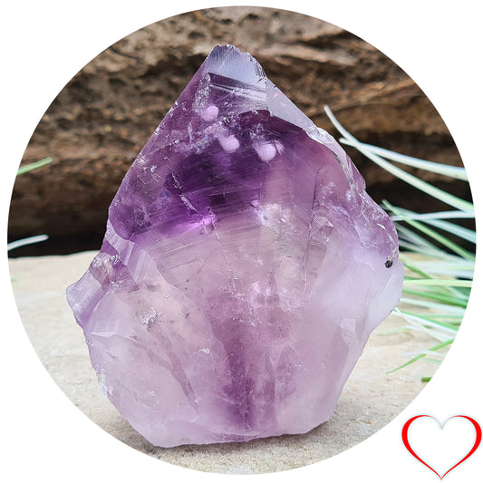 Amethyst standing point with cut base from Brazil. This is a great crystal with lovely purple colouring, and it looks to have 3 white bubble like inclusions near the tip. Point is polished, the rest is left natural. Base is cut flat.