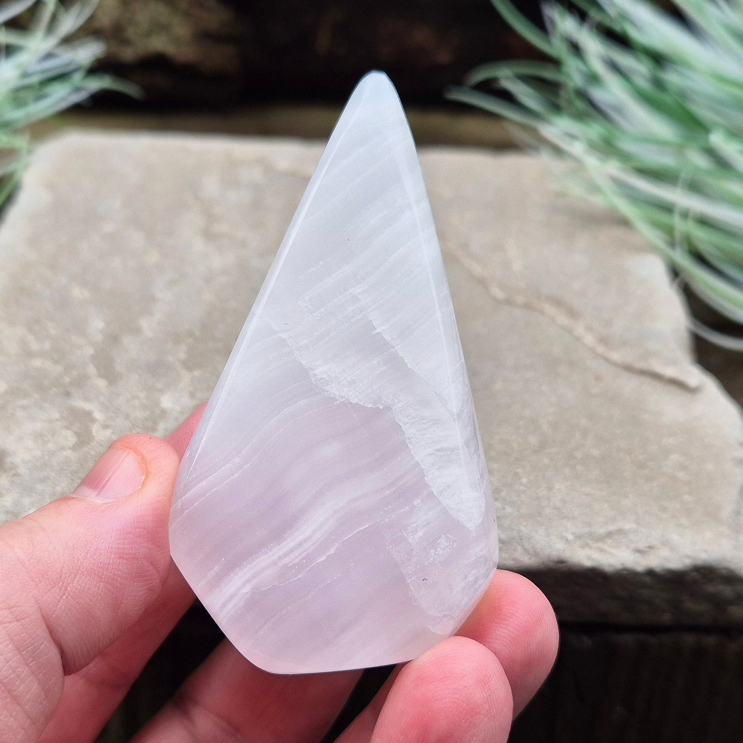 Mangano Calcite Crystal Free Form, Polished, does have the visible stripy banding which does not always show up in the photos of videos. Also known as Pink Calcite.