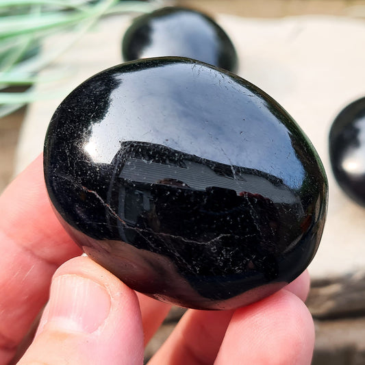 Polished Black Tourmaline crystal from Brazil. Really lovely polished pieces of Black Tourmaline with a shiny lustre. Black Tourmaline is also known as Schorl. Oval shaped.