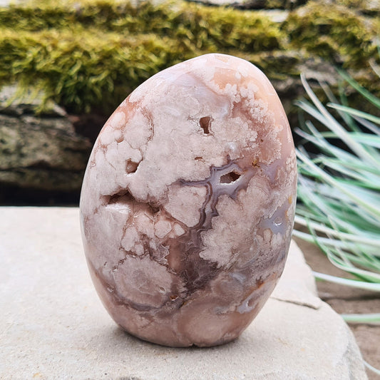 Cherry Blossom Agate Crystal Free Form, also known as Blossom Agate or Flower Agate, is a beautiful variety of Pink Chalcedony that originates from Madagascar. This stone is recognized for its distinctive, flower-like patterns that resemble blooming blossoms