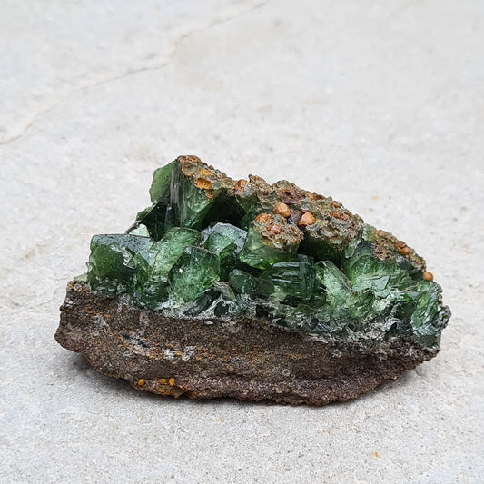 Natural Ludlamite crystal from São Gabriel da Cachoeira, Brazil, featuring a vibrant deep green color. This rare phosphate mineral, discovered in 1954 and named after mineralogist William H. Ludlam, is a must-have for collectors.