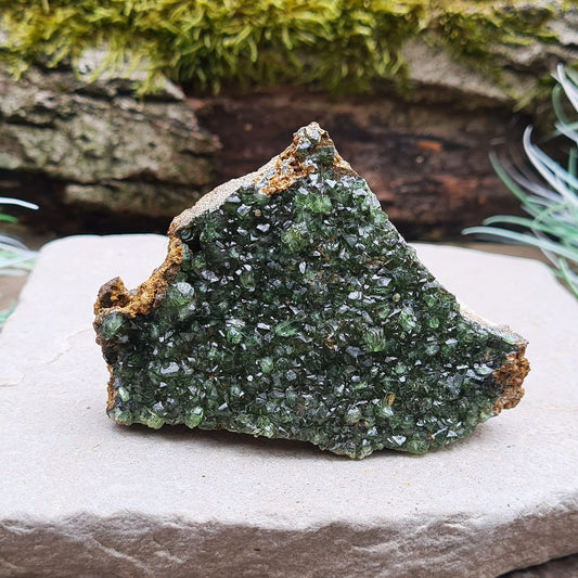 Ludlamite crystal in its natural matrix, a rare deep green phosphate mineral from São Gabriel da Cachoeira, Amazonas, Brazil. Ideal for crystal collectors. Discovered in 1954 and named after mineralogist William H. Ludlam.